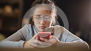 Asian teenager chatting socialmedia on mobile phone