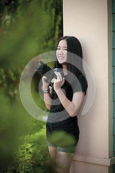 Asian teenager and dslr camera in hand toothy smiling with happiness face