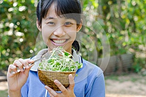 Asian Teenager Girl Happy with The Vegetable Sunflower Sprouts.