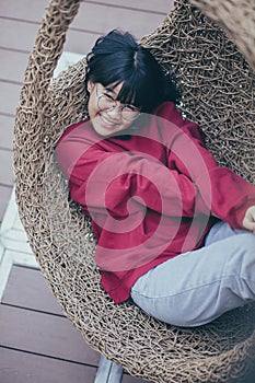 Asian teenager relaxing on a bamboo cradle