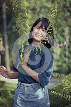 asian teenager relaxing in fern botanical garden