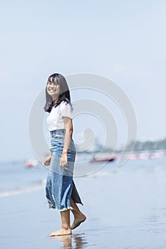 Asian teenager relaxing with happiness on vacation sea beach