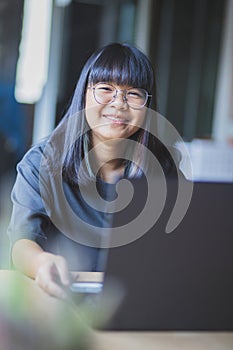 Asian teenager studying online at home while outbreaking of covid-19