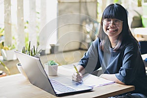 Asian teenager studying online at home while outbreaking of covid-19 photo