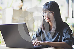 Asian teenager studying online at home while outbreaking of covid-19 photo