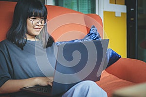 Asian teenager studying online at home while outbreaking of covid-19 photo