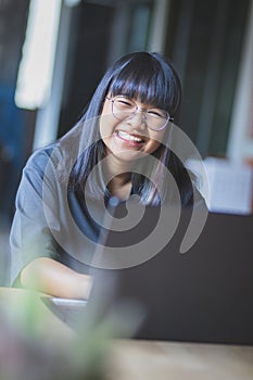 Asian teenager studying online at home while outbreaking of covid-19 photo