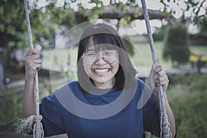 asian teenager toothy smiling with happiness face in kid park