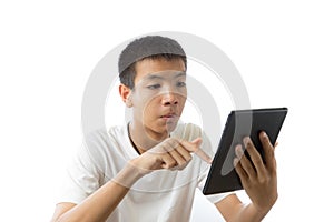 Asian teenager using his tablet with concentration