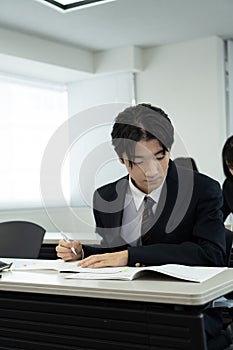 Asian teenagers in high school uniform studying in class