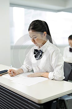 Asian teenagers in high school uniform studying in the class