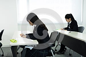 Asian teenagers in high school uniform studying in class