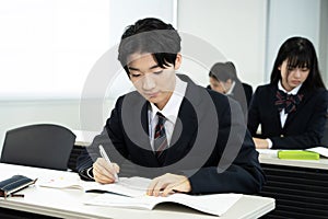 Asian teenagers in high school uniform studying in class