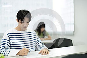 Asian teenagers studying in a tuition class