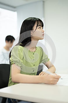 Asian teenagers studying in a tuition class