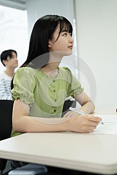 Asian teenagers studying in a tuition class