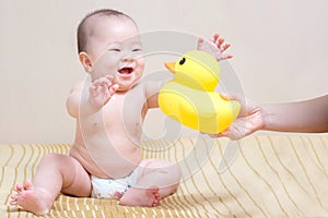 Asian thai baby girl playing with yellow duck