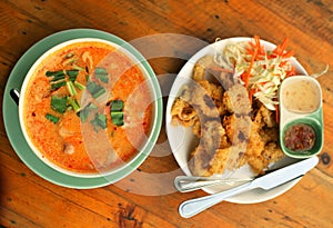 Asian thai cuisine red curri soup with shrimps photo