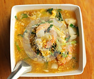 Asian thai cuisine soup with curri shrimps and vegetables photo