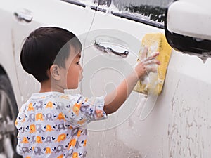 Asian Thai cute kid washing car