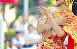 Asian Thai Female dresses the vintage traditional dress and dances with the Thai dance style at the outdoor in the event.,