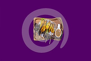 Asian Thai food on white plates with purple background with copy