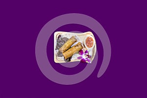 Asian Thai food on white plates with purple background with copy