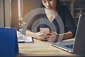 Asian Thai girl using mobile phon in business market.Young woman sadness,broken heart and depressed about bad relationship.Person