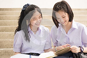 Asian Thai high schoolgirls student couple in school studying