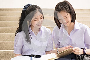 Asian Thai high schoolgirls student couple in school studying photo