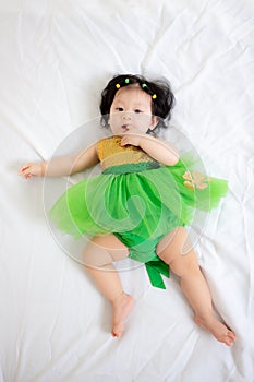 Asian Thai Sweet Baby Girl in Green Dress, Saint Patrick`s Day