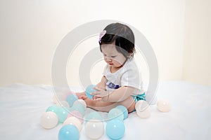 Asian Thai Sweet Baby Girl Play with Pastel Balls