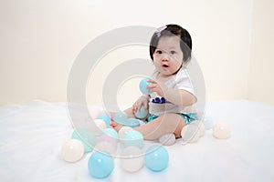 Asian Thai Sweet Baby Girl Play with Pastel Balls