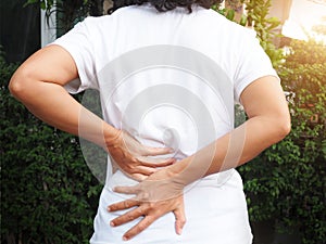 Asian Thai women with body aches suffering muscle injury with waist pain and back pain