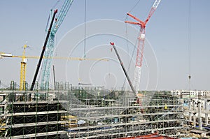 Asian thai workers and heavy machinery working builder new building at construction site high-rise building in Bangkok, Thailand.