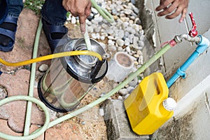 Asian Thailand termite staff company is spraying the destroy chemical liquid in to white ant nest in the wood around human house