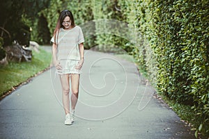 Asian thin hipster girl wearing sunglasses walking smiling