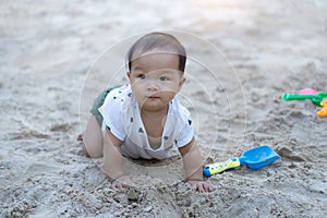 Asian toddler baby thai girl playing with sand