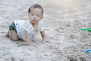 Asian toddler baby thai girl playing with sand