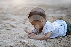 Asian toddler baby thai girl playing with sand