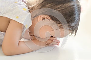 Asian toddler girl prostrate herself to elder for thanks