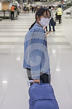 An Asian tourist girl, takes a mask every time she does in her daily life.