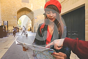 Asian tourist looking on map searching for direction