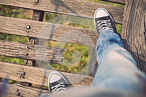 Asian tourist man walking on the old and broken wood bridge