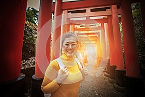 Asian tourist toothy smiling face in fushimi inari shrine one o