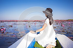 Asian tourist woman on a blue long tail boat at amazing Red lotus sea. unseen in Thailand, tourism Thailand, Udon Thani Province