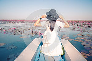 Asian tourist woman on a blue long tail boat at amazing Red lotus sea. unseen in Thailand, tourism Thailand, Udon Thani Province