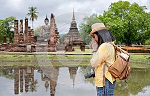 Asian tourist woman pay respect to buddha at ancient of pagoda temple thai architecture at Sukhothai,Thailand. Female traveler in