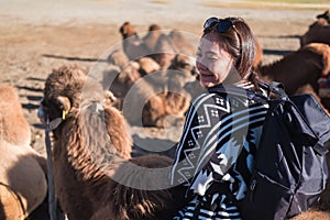 Asian tourist woman riding camel in the Hunder desert , Ladakh India photo