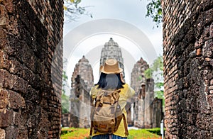 Asian tourist woman take a photo of ancient of pagoda temple thai architecture at Sukhothai,Thailand. Female traveler in casual t